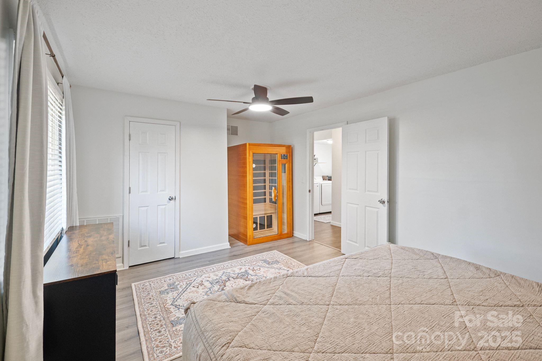 5703 Valley Field Road Southeast Hickory, NC 28602 - Photo 16 of 33 a bedroom with a bed and a chandelier