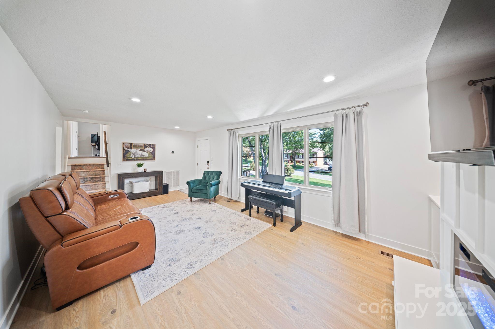 5703 Valley Field Road Southeast Hickory, NC 28602 - Photo 2 of 33 a living room with furniture and a wooden floor