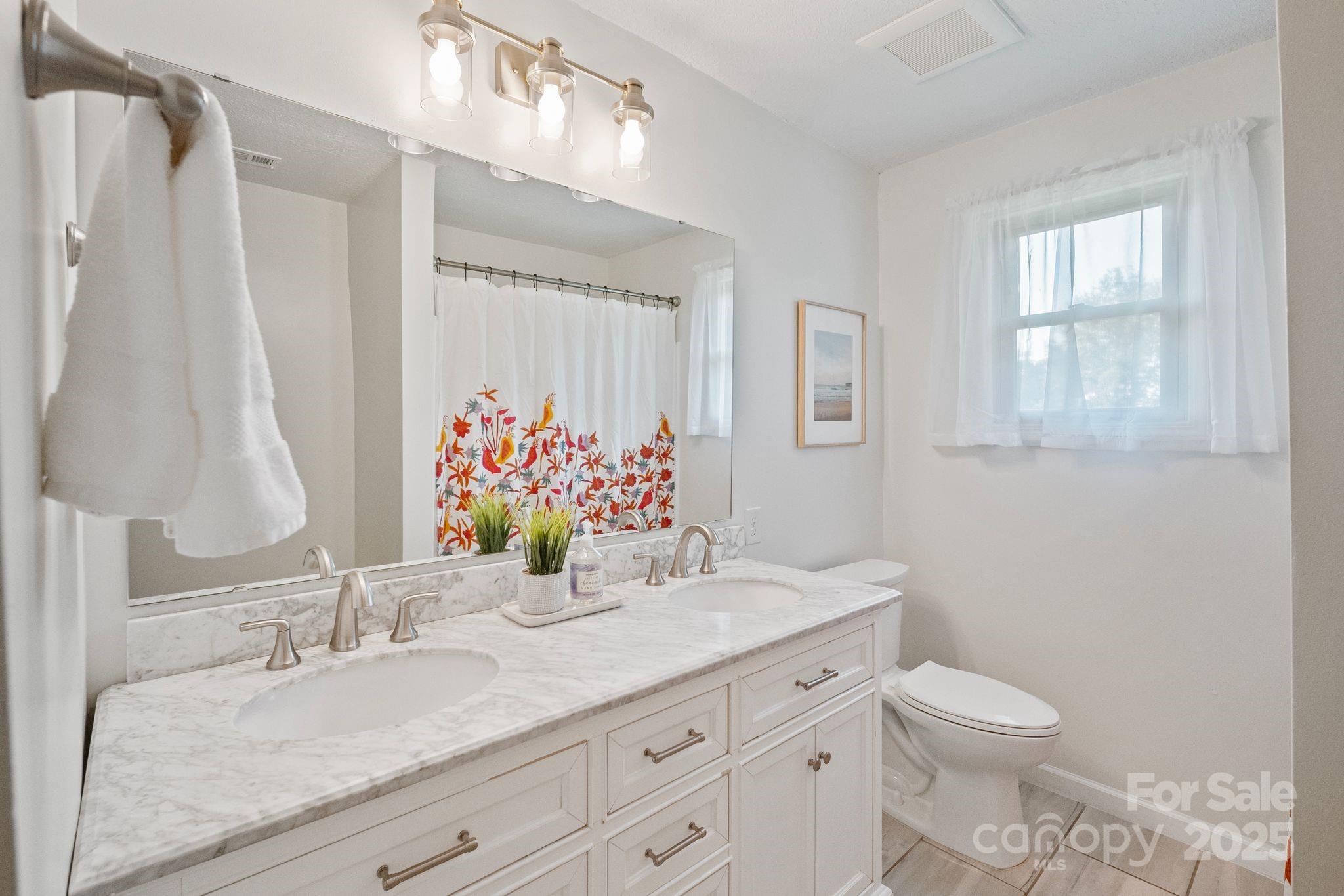 5703 Valley Field Road Southeast Hickory, NC 28602 - Photo 21 of 33 a bathroom with a granite countertop sink toilet and mirror
