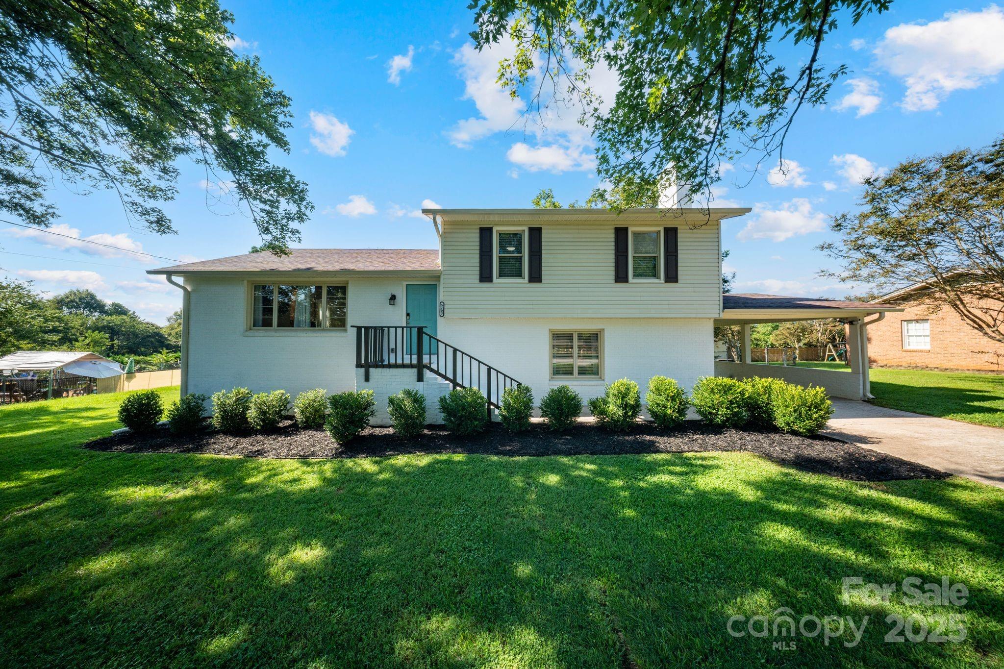 5703 Valley Field Road Southeast Hickory, NC 28602 - Photo 5 of 33 a front view of a house with a garden and plants