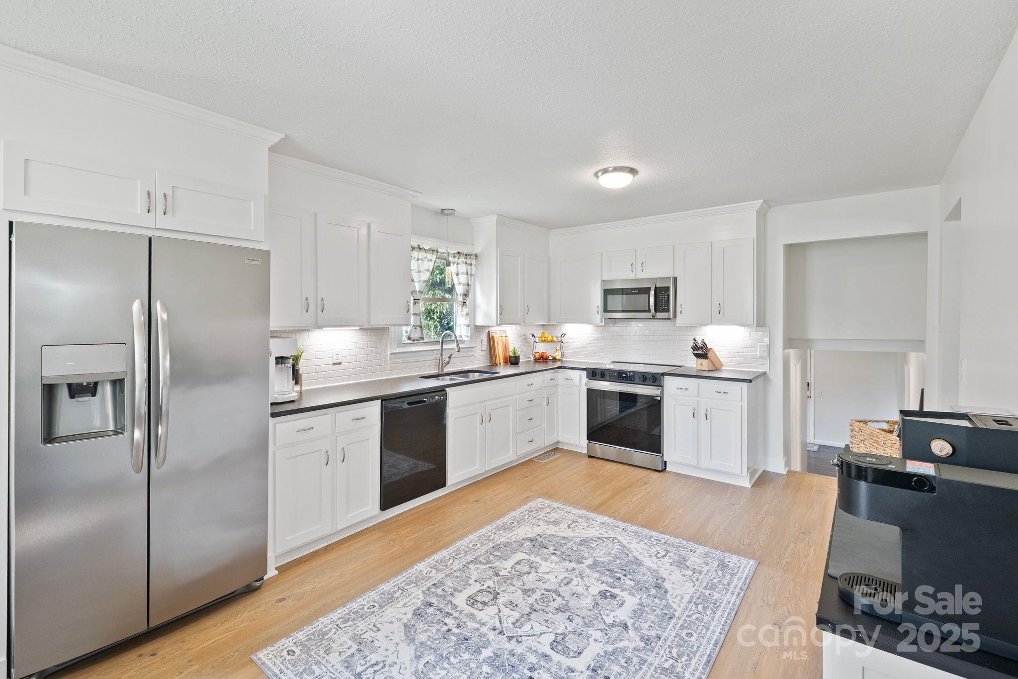 5703 Valley Field Road Southeast Hickory, NC 28602 - Photo 10 of 33 a kitchen with stainless steel appliances granite countertop a refrigerator sink and stove