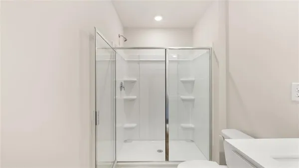 a bathroom with a shower and a glass door
