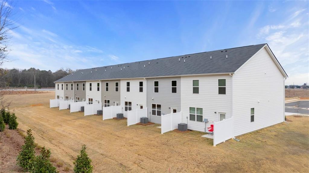 121 Kenmore Circle Perry, GA 31069 - Photo 27 of 28 a view of white house with table and chairs