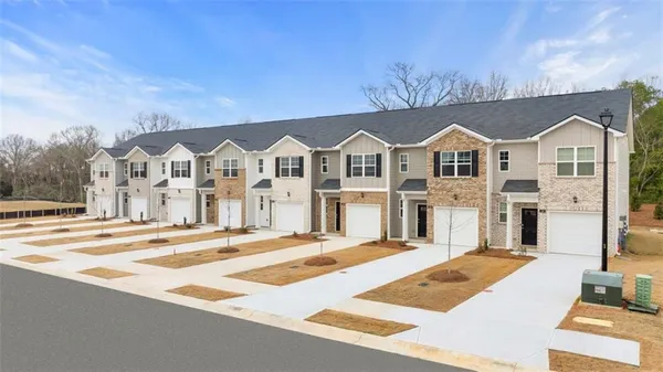a front view of a house with a yard