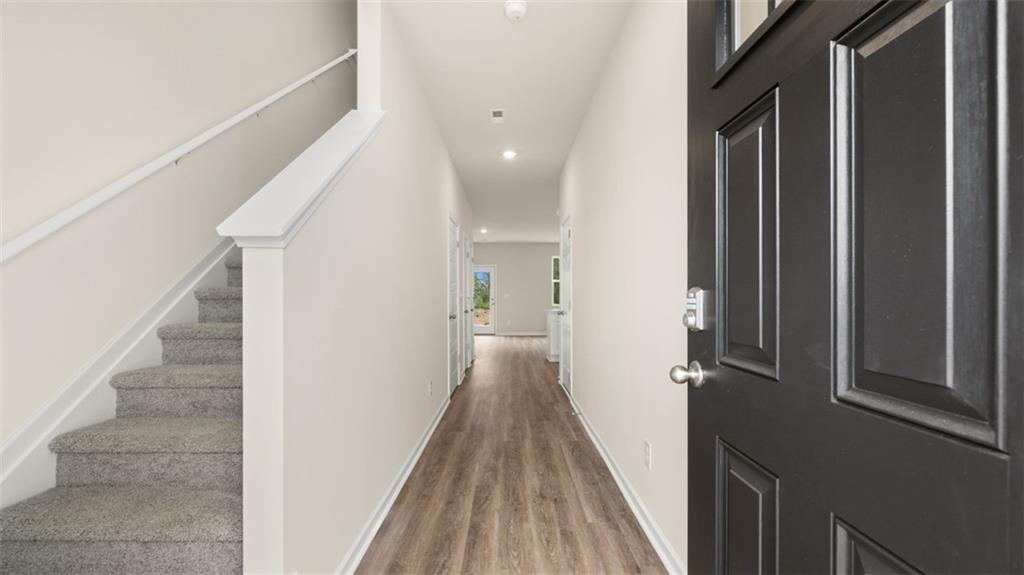 121 Kenmore Circle Perry, GA 31069 - Photo 5 of 28 a view of a hallway with wooden floor and staircase