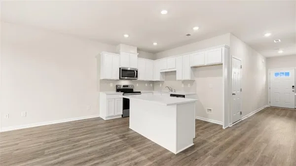 a kitchen with stainless steel appliances a refrigerator sink and microwave