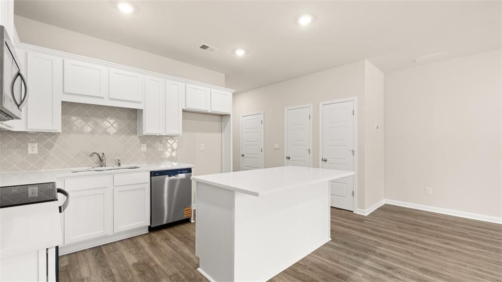 121 Kenmore Circle Perry, GA 31069 - Photo 10 of 28 a kitchen with a sink a stove and cabinets