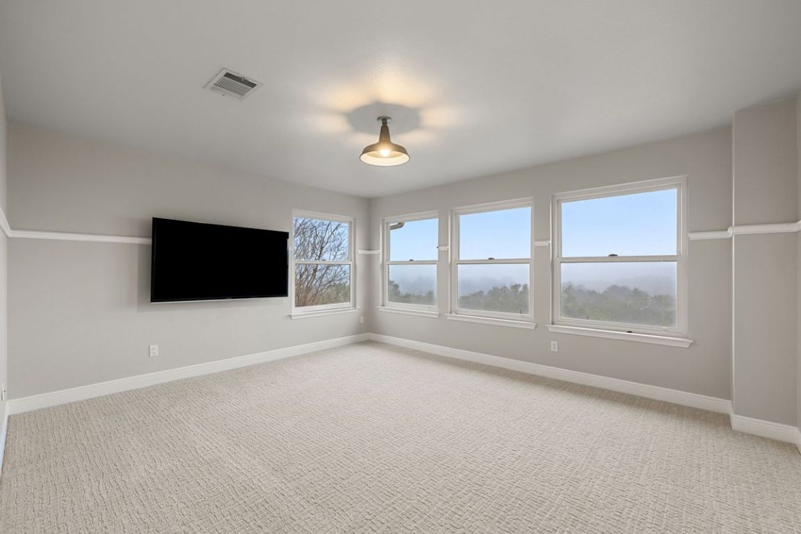 2137 Rivina Drive Austin, TX 78733 - Photo 26 of 39 Empty room with light carpet and baseboards