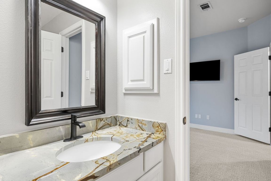 2137 Rivina Drive Austin, TX 78733 - Photo 29 of 39 Bathroom with vanity and light carpet