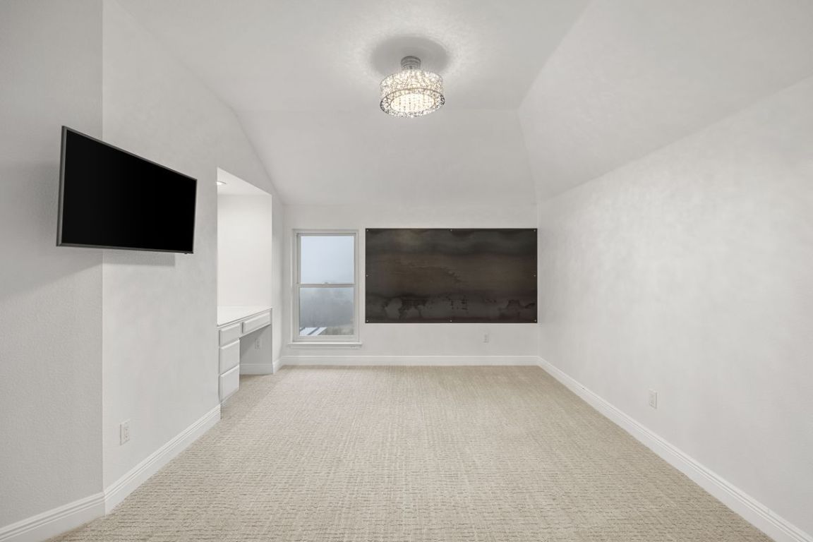 2137 Rivina Drive Austin, TX 78733 - Photo 30 of 39 Unfurnished living room with light carpet and lofted ceiling