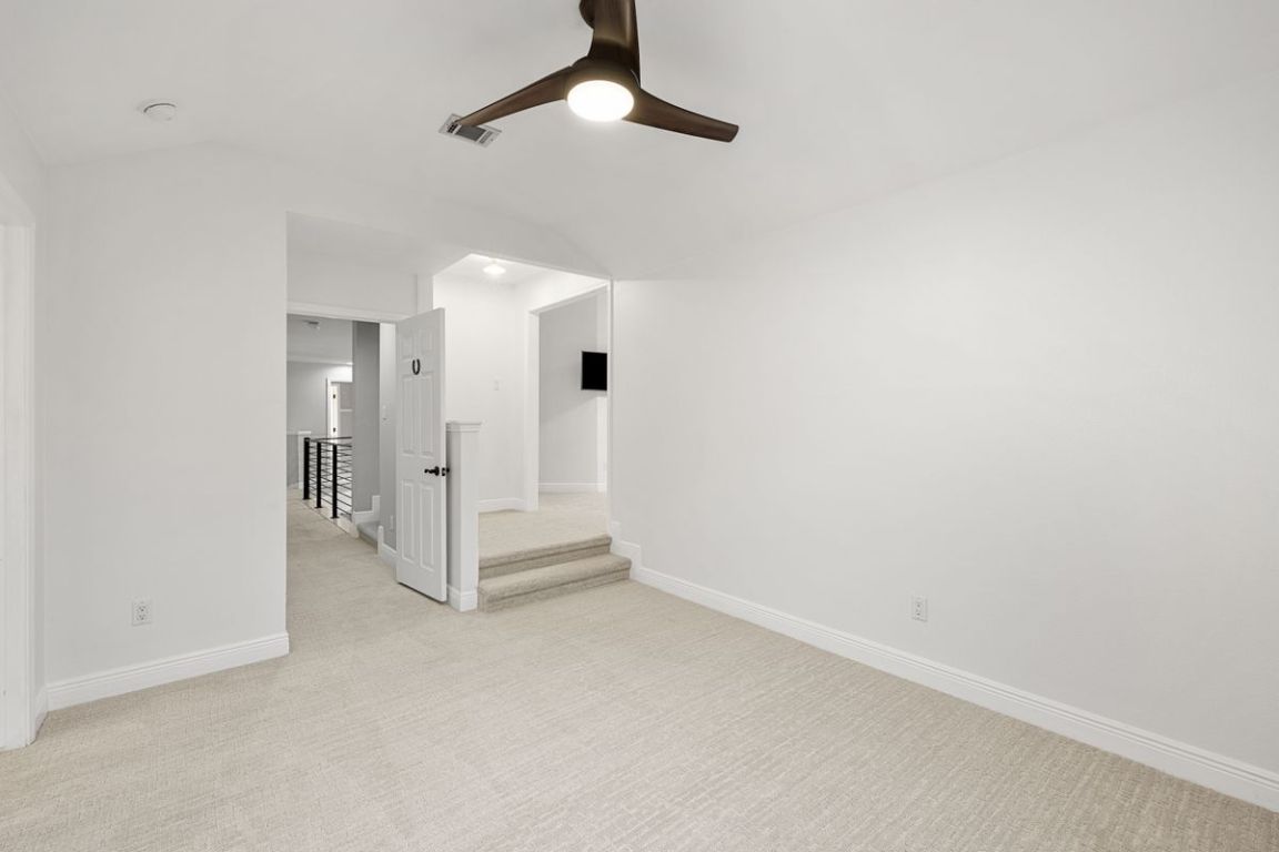 2137 Rivina Drive Austin, TX 78733 - Photo 31 of 39 Empty room with light colored carpet, ceiling fan, and lofted ceiling