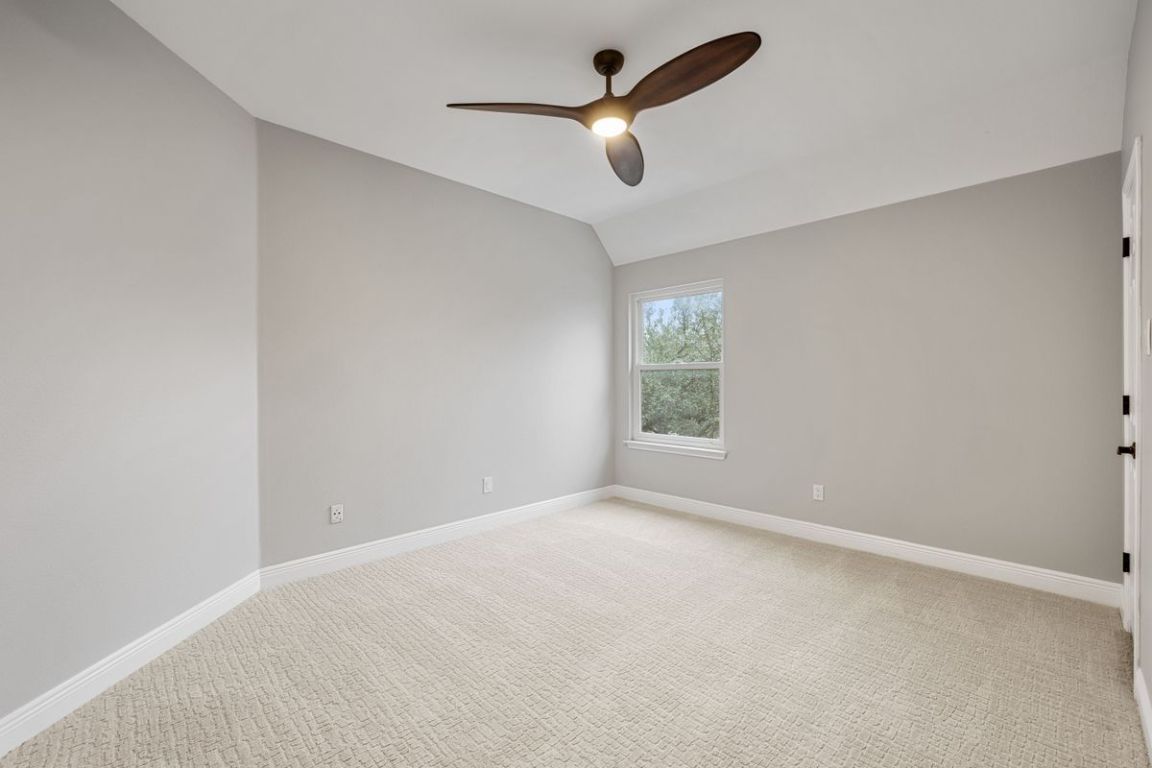 2137 Rivina Drive Austin, TX 78733 - Photo 33 of 39 Empty room featuring lofted ceiling, light colored carpet, and ceiling fan