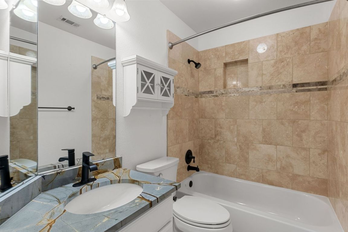 2137 Rivina Drive Austin, TX 78733 - Photo 34 of 39 Full bathroom with bathtub / shower combination and vanity