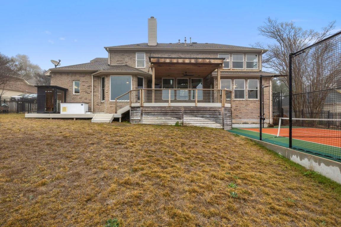 2137 Rivina Drive Austin, TX 78733 - Photo 38 of 39 Back of property featuring a chimney, brick siding, a deck, a patio, and ceiling fan