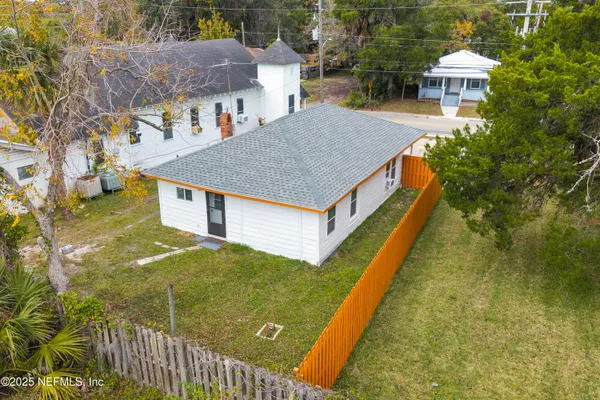 a aerial view of a house with a yard