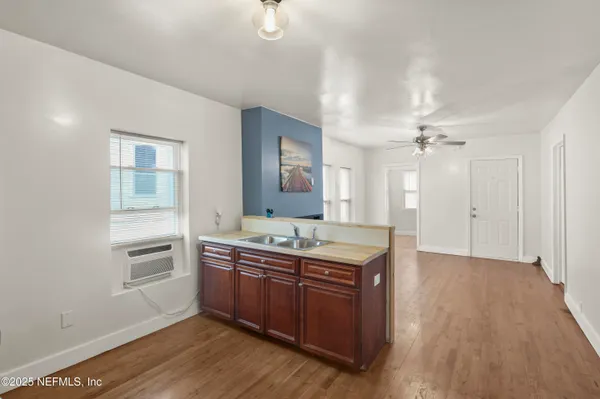 a spacious bathroom with a granite countertop sink and a mirror