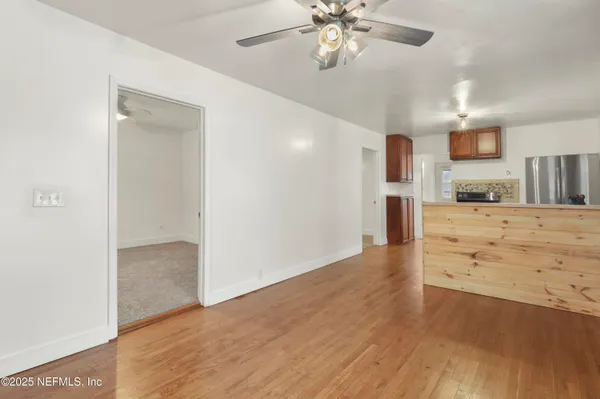 a view of a kitchen with a sink and a chandelier fan