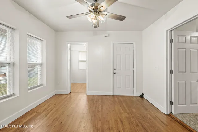 a view of a kitchen with a sink and a chandelier fan