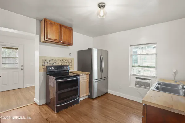 a kitchen with a refrigerator stove and sink