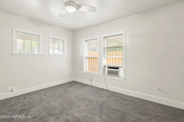 an empty room with a empty space and windows