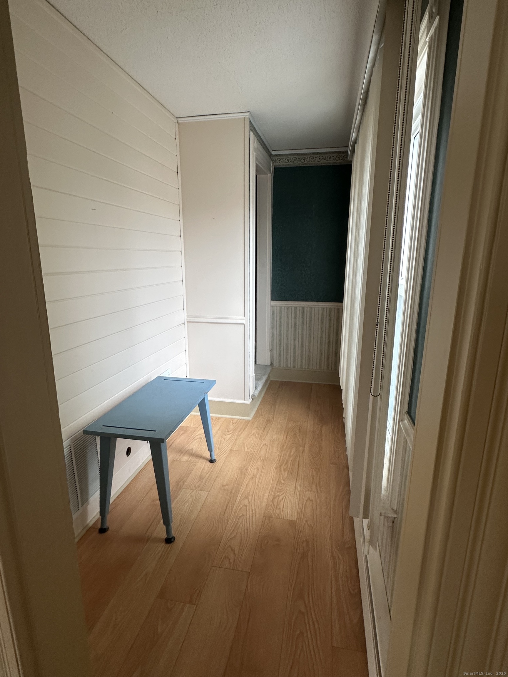 421 Main Street Wallingford, CT 06492 - Photo 16 of 27 a view of wooden floor and chair in a room