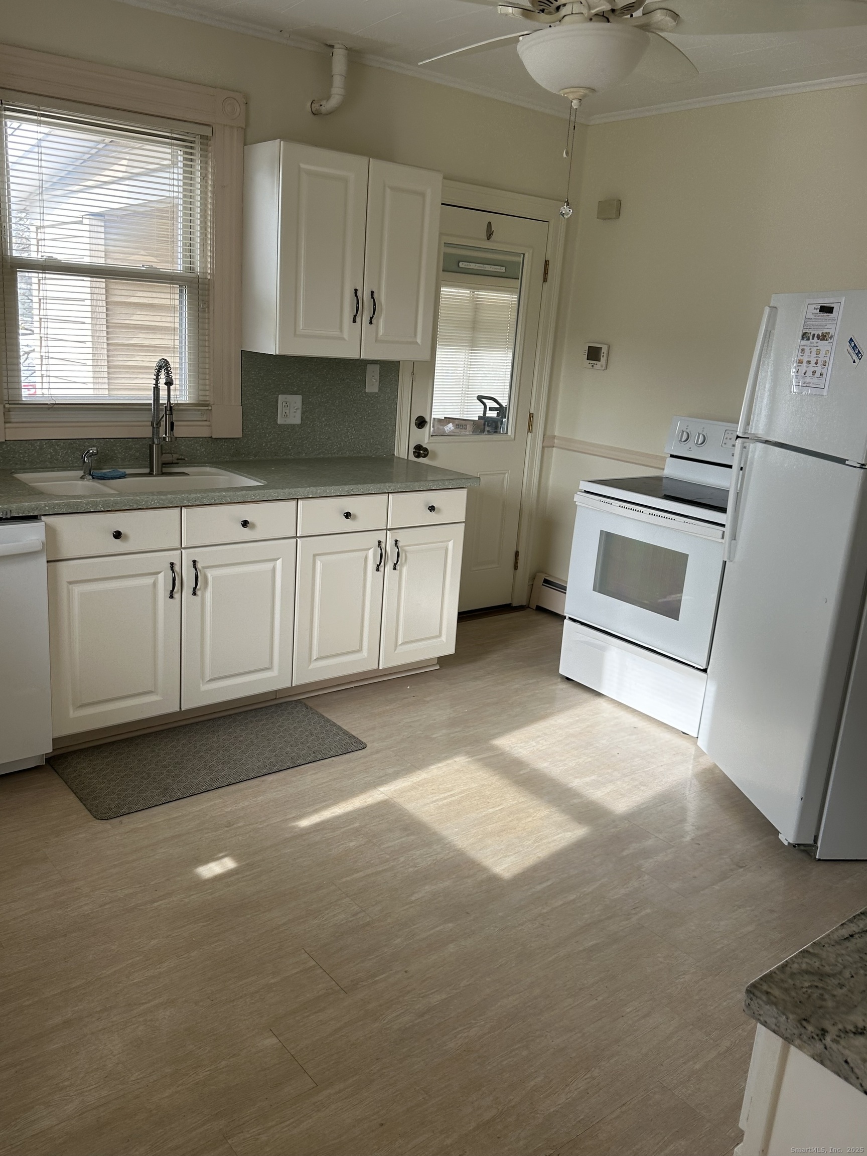 421 Main Street Wallingford, CT 06492 - Photo 22 of 27 a kitchen with granite countertop a sink a stove a microwave and cabinets