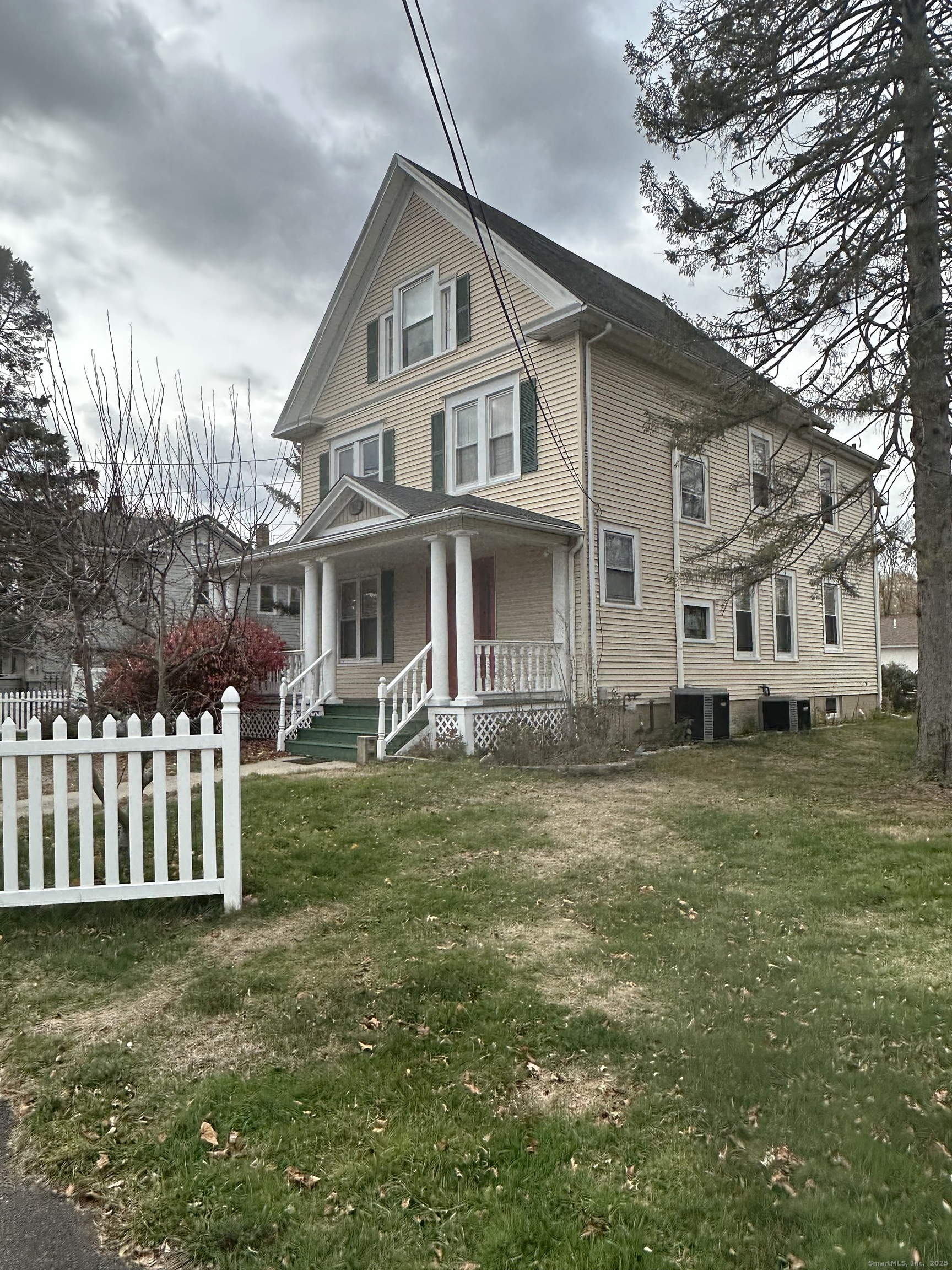421 Main Street Wallingford, CT 06492 - Photo 3 of 27 a front view of a house with a garden