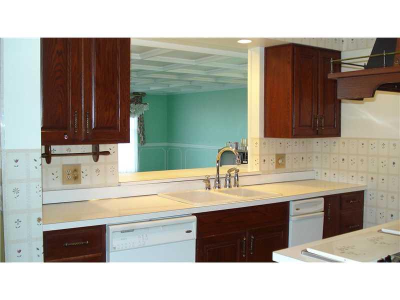 497 Stone Church Road Hunker, PA 15639 - Photo 8 of 25 Kitchen. SINK AREA OF KITCHEN WITH PASS THRU TO DININGROOM