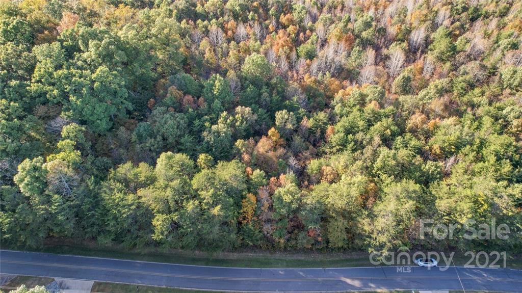 456 Shamrock Road New London, NC 28127 - Photo 4 of 10 a view of a city with lush green forest