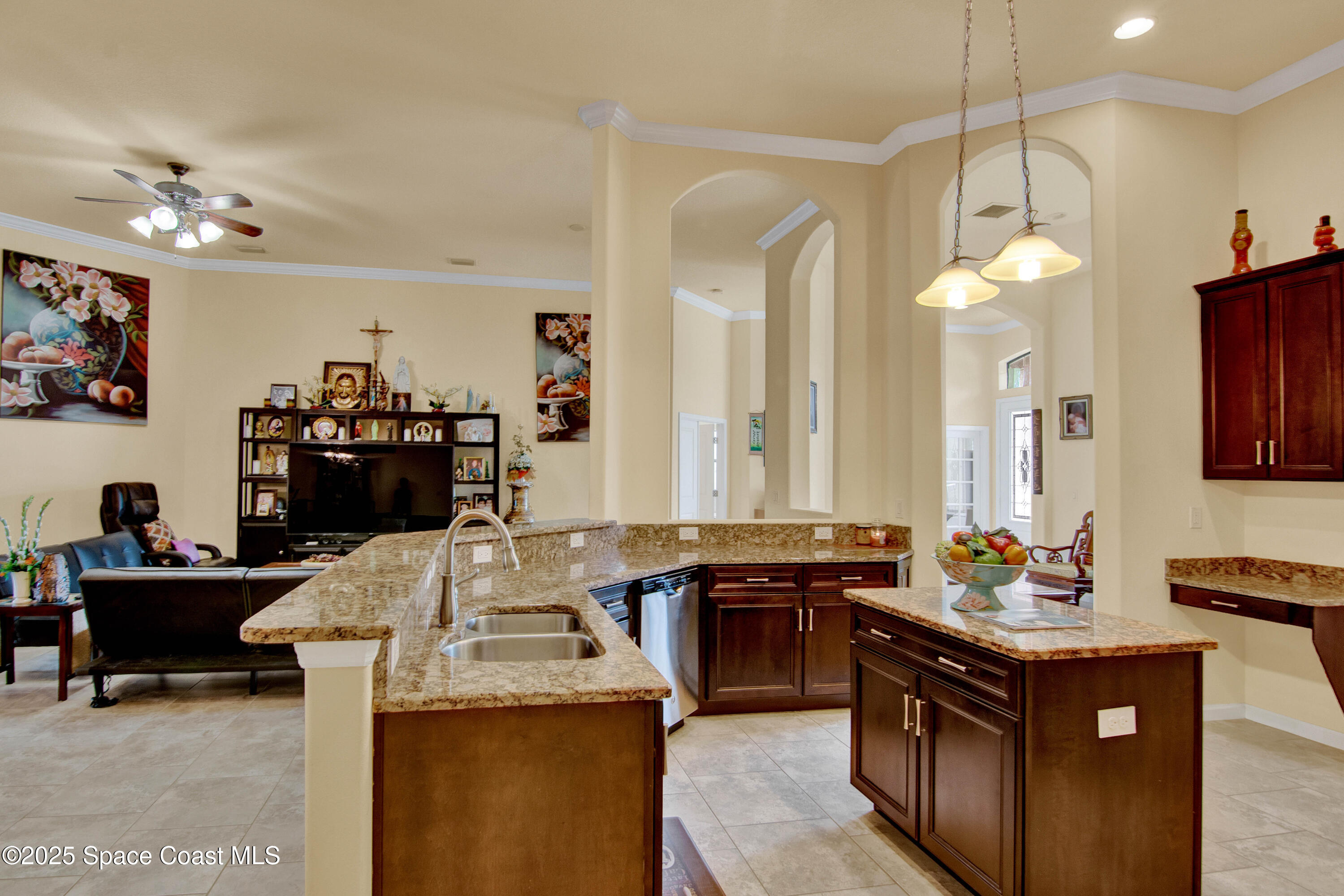 900 Hall Road Malabar, FL 32950 - Photo 11 of 28 a kitchen island with granite countertop a sink dishwasher stove and cabinets