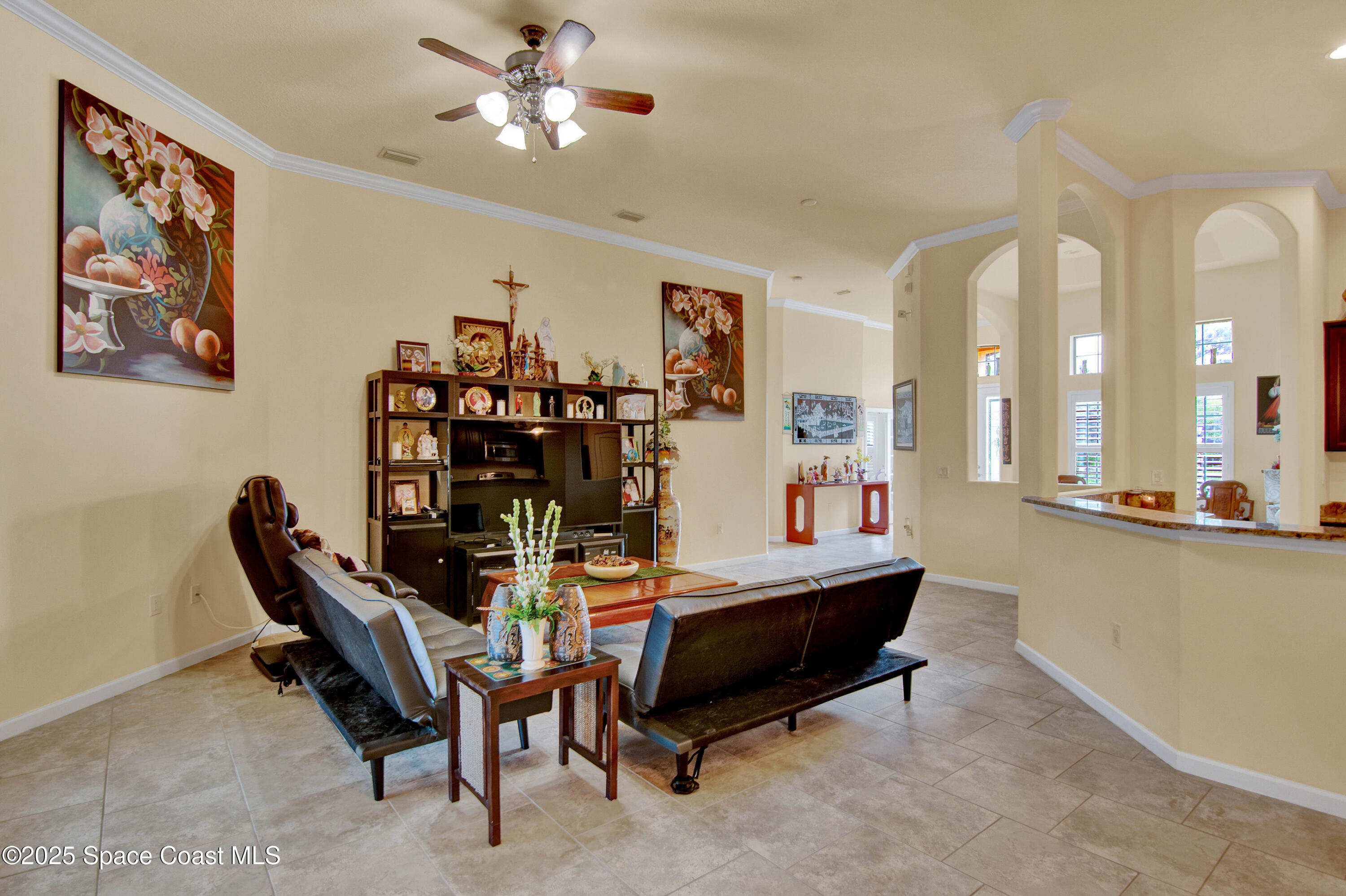 900 Hall Road Malabar, FL 32950 - Photo 12 of 28 a living room with furniture a chandelier furniture and a window