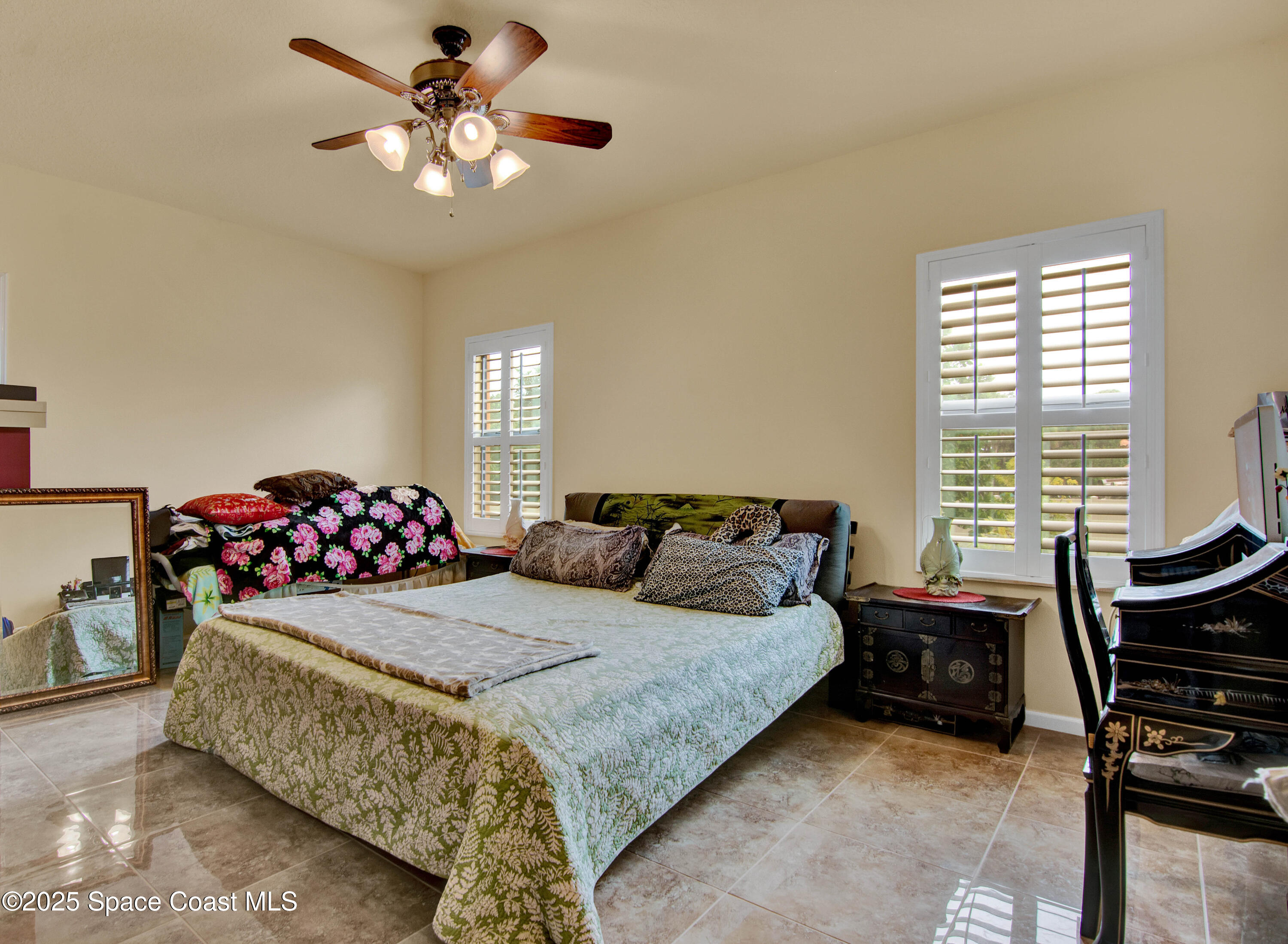 900 Hall Road Malabar, FL 32950 - Photo 14 of 28 a bedroom with a bed and a chandelier