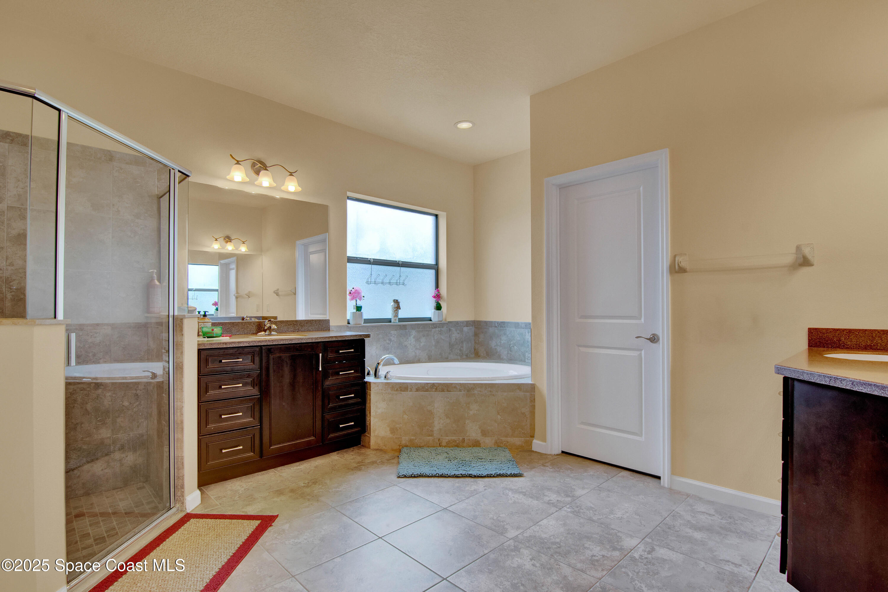 900 Hall Road Malabar, FL 32950 - Photo 15 of 28 a large bathroom with a double vanity sink and a mirror