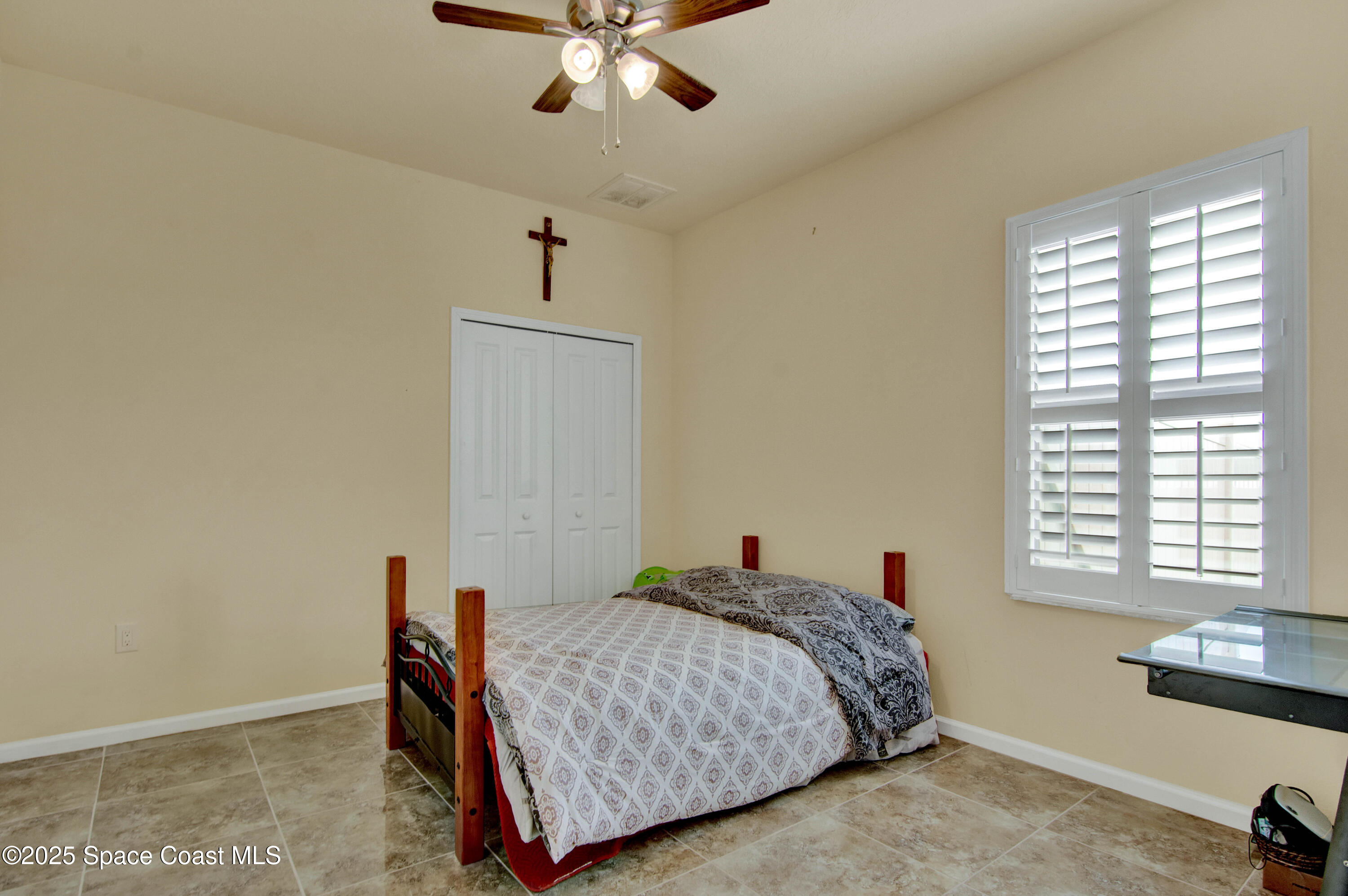 900 Hall Road Malabar, FL 32950 - Photo 17 of 28 a bed room with a bed and a chandelier