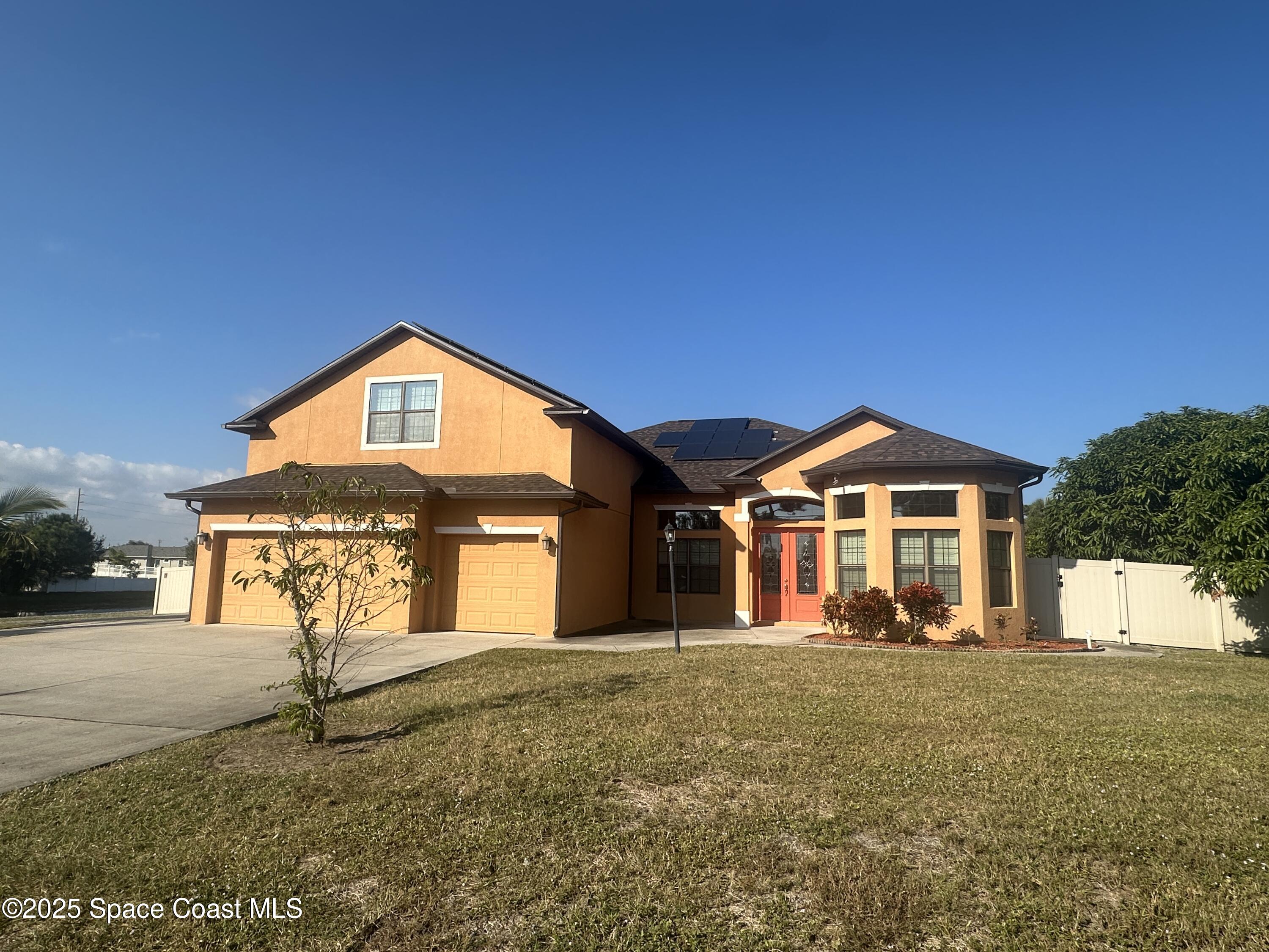 900 Hall Road Malabar, FL 32950 - Photo 2 of 28 a front view of a house with a yard