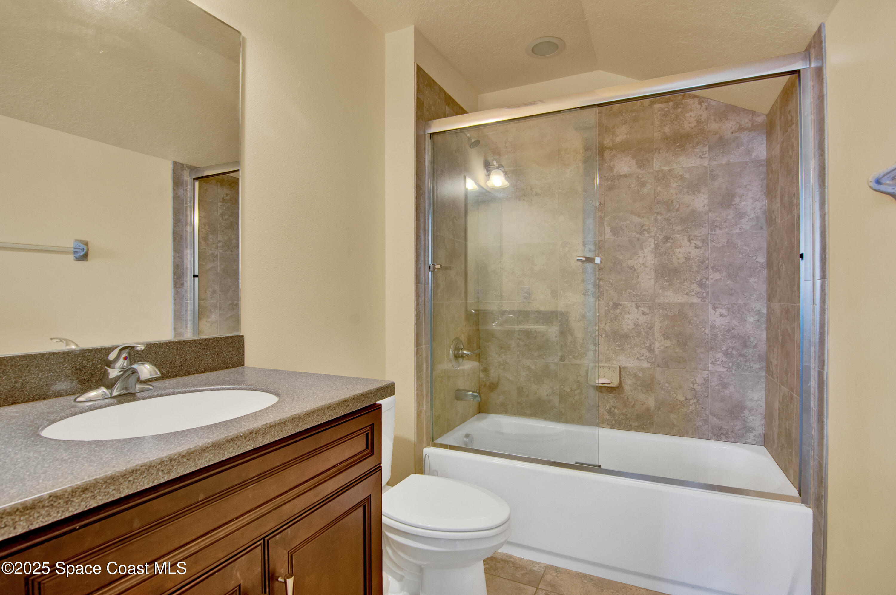 900 Hall Road Malabar, FL 32950 - Photo 21 of 28 a bathroom with a granite countertop sink toilet and shower