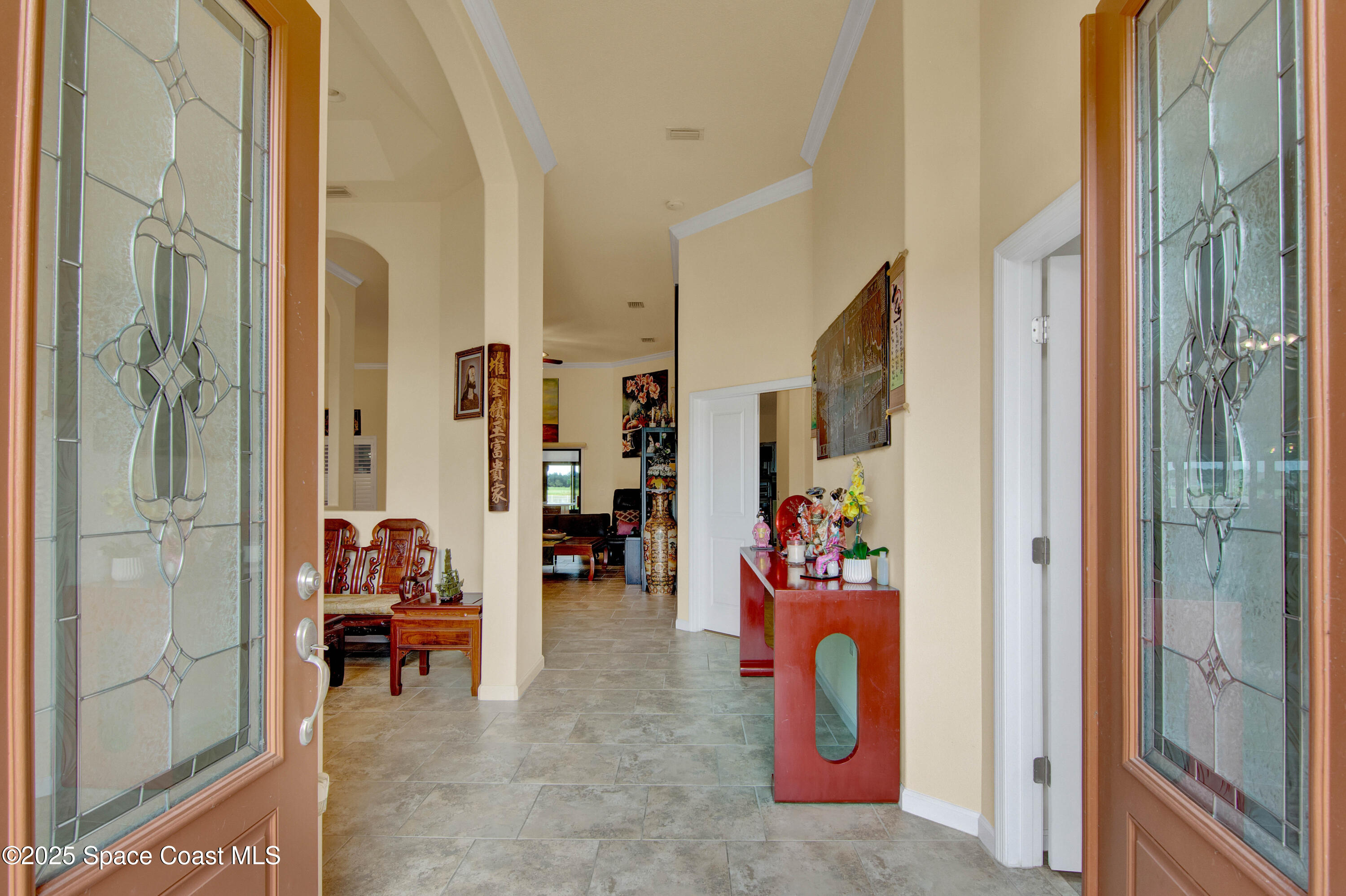 900 Hall Road Malabar, FL 32950 - Photo 4 of 28 a living room with furniture and a painting on the wall