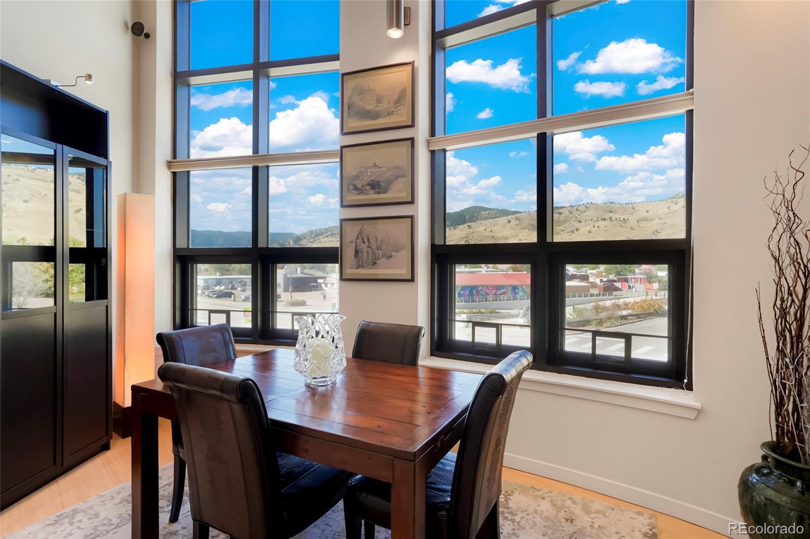 a view of a dining room with furniture large window and wooden floor