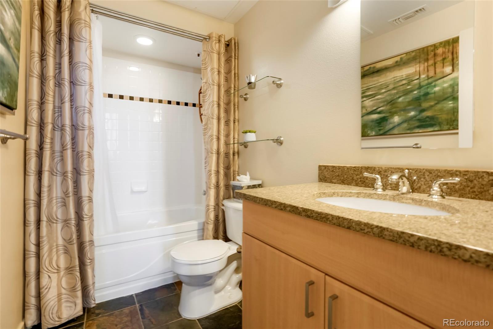4520 Broadway, Unit 207 Boulder, CO 80304 - Photo 14 of 28 a bathroom with a granite countertop sink toilet and shower