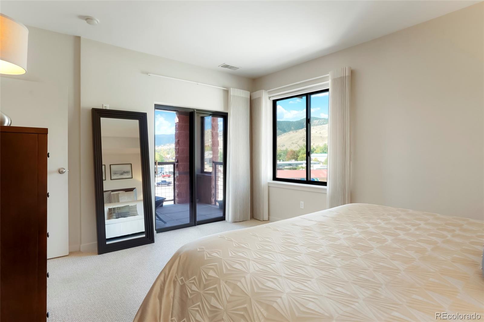 4520 Broadway, Unit 207 Boulder, CO 80304 - Photo 19 of 28 a bedroom with a bed and a large window