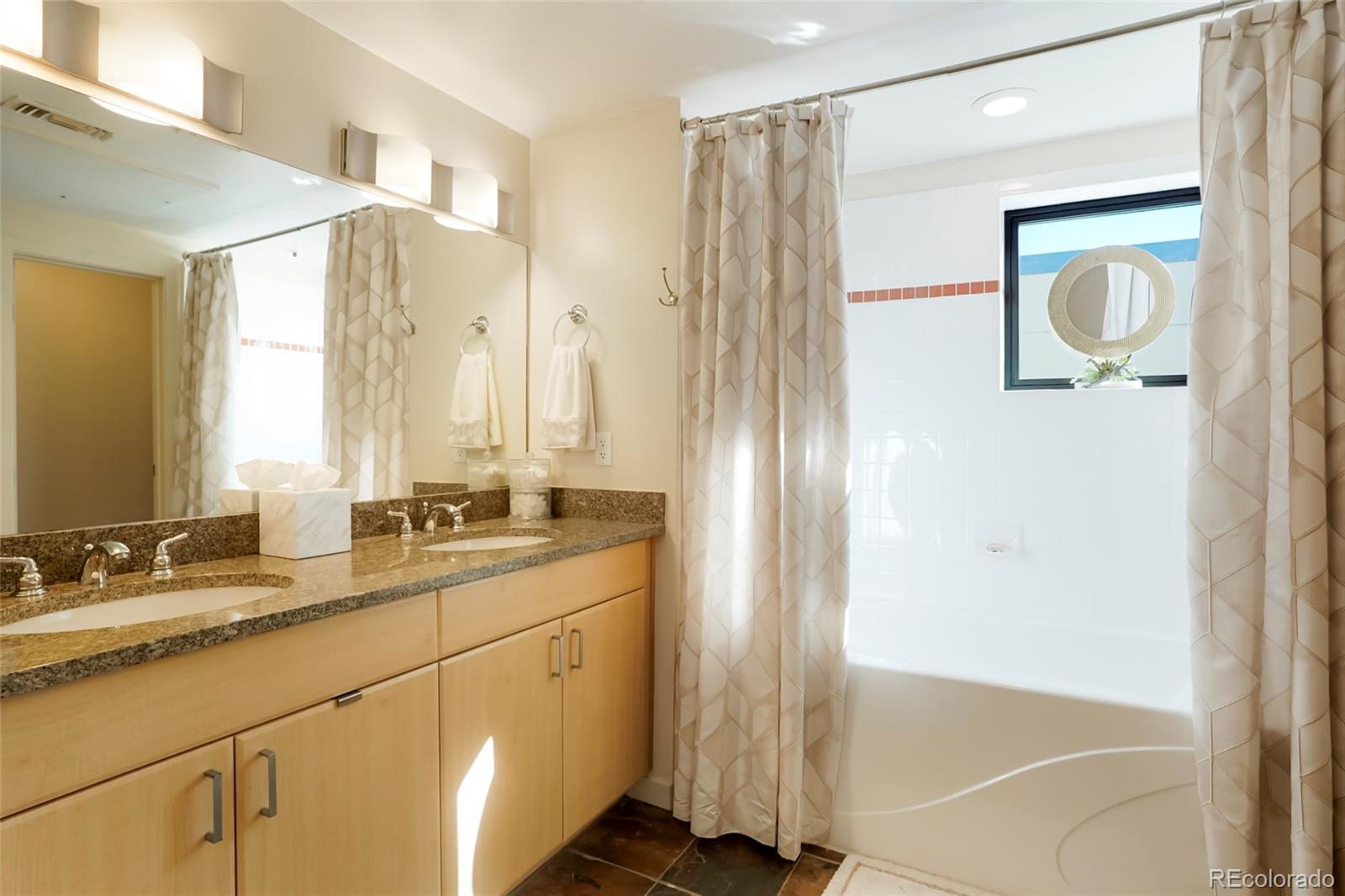 4520 Broadway, Unit 207 Boulder, CO 80304 - Photo 23 of 28 a bathroom with a double vanity sink mirror and shower
