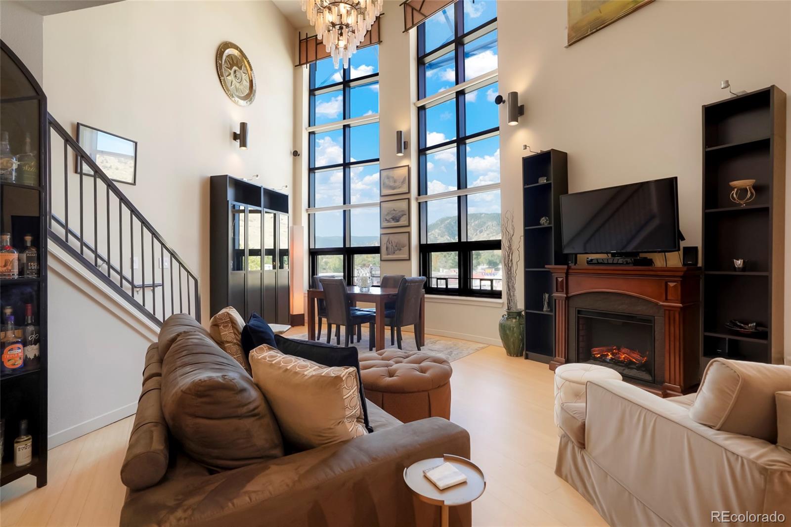 4520 Broadway, Unit 207 Boulder, CO 80304 - Photo 6 of 28 a living room with furniture a fireplace and a flat screen tv