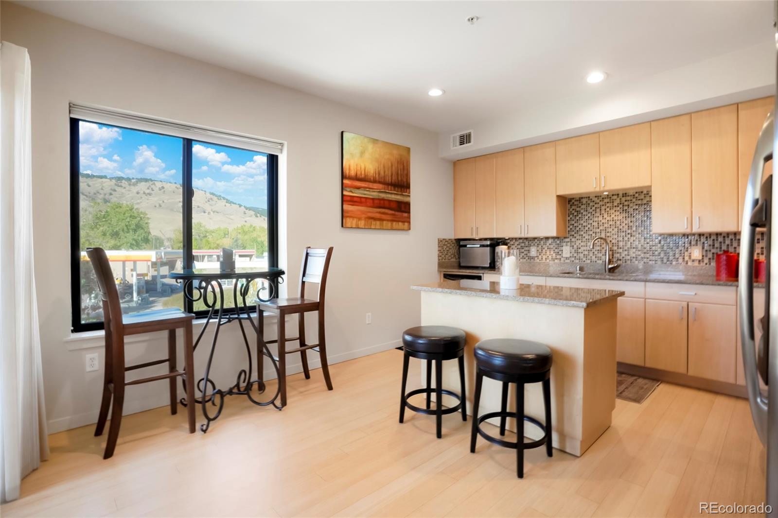 4520 Broadway, Unit 207 Boulder, CO 80304 - Photo 8 of 28 a kitchen with kitchen island a table and chairs in it