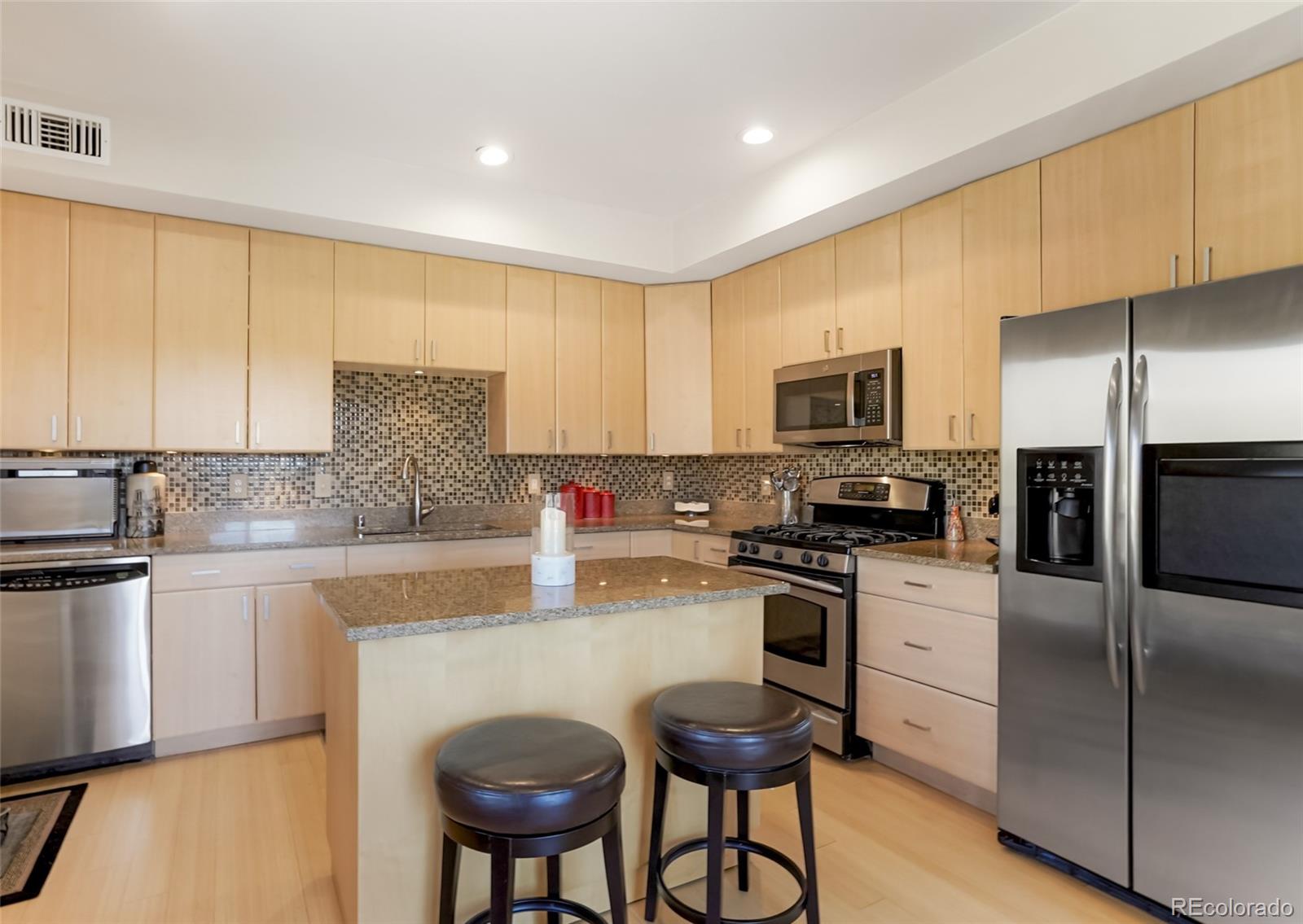 4520 Broadway, Unit 207 Boulder, CO 80304 - Photo 10 of 28 a kitchen with granite countertop a stove a sink dishwasher a refrigerator with a dining table and chairs