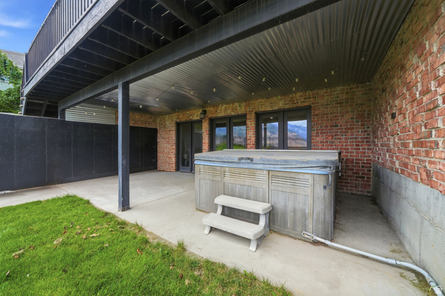 767 Draper View Road Draper, UT 84020 - Photo 56 of 71 Covered patio with a built-in hot tub, concrete flooring, and a corrugated metal ceiling