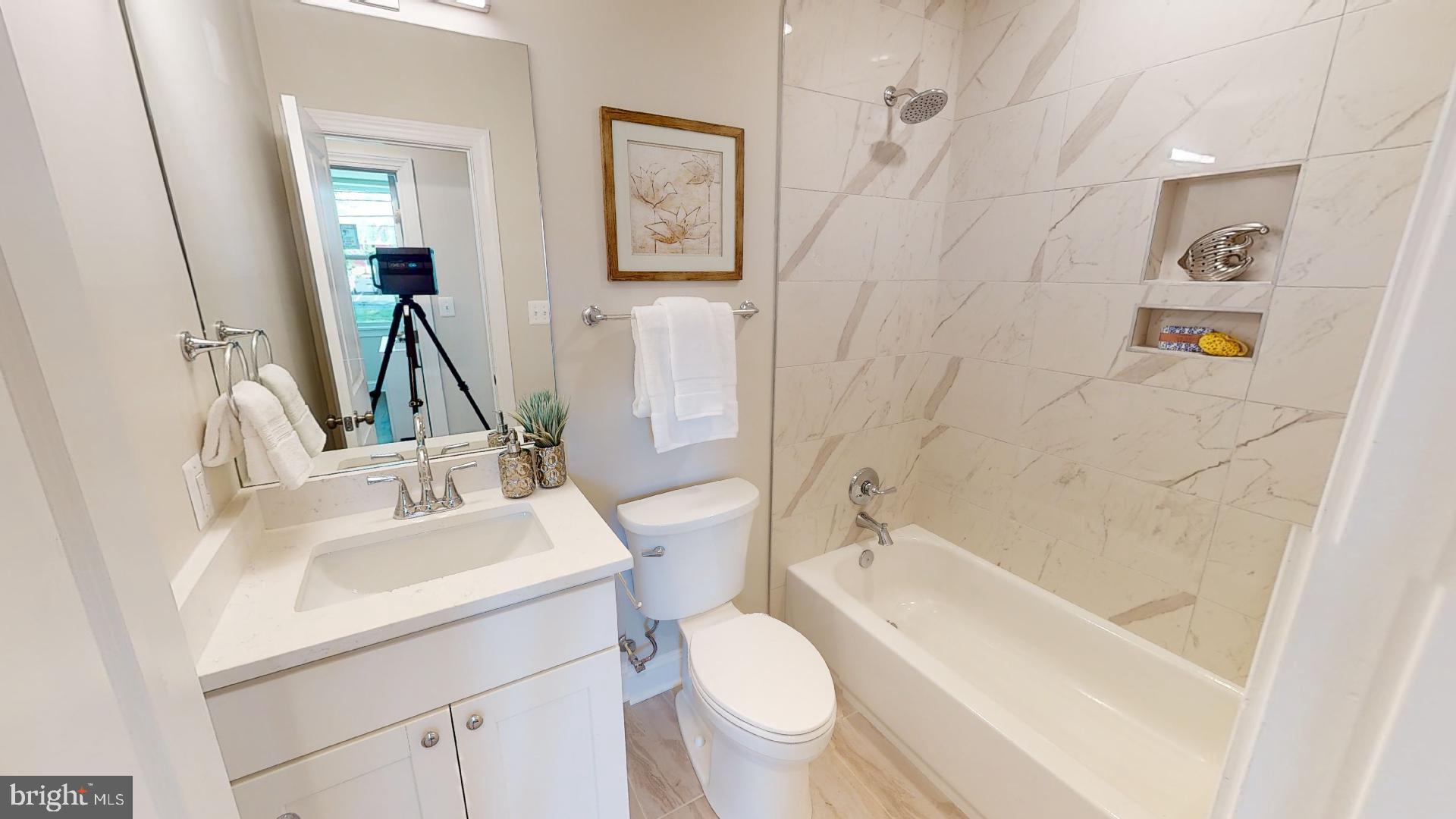 220 Hamilton Street Northwest, Unit 104 Washington, DC 20011 - Photo 7 of 11 a bathroom with a sink toilet and shower