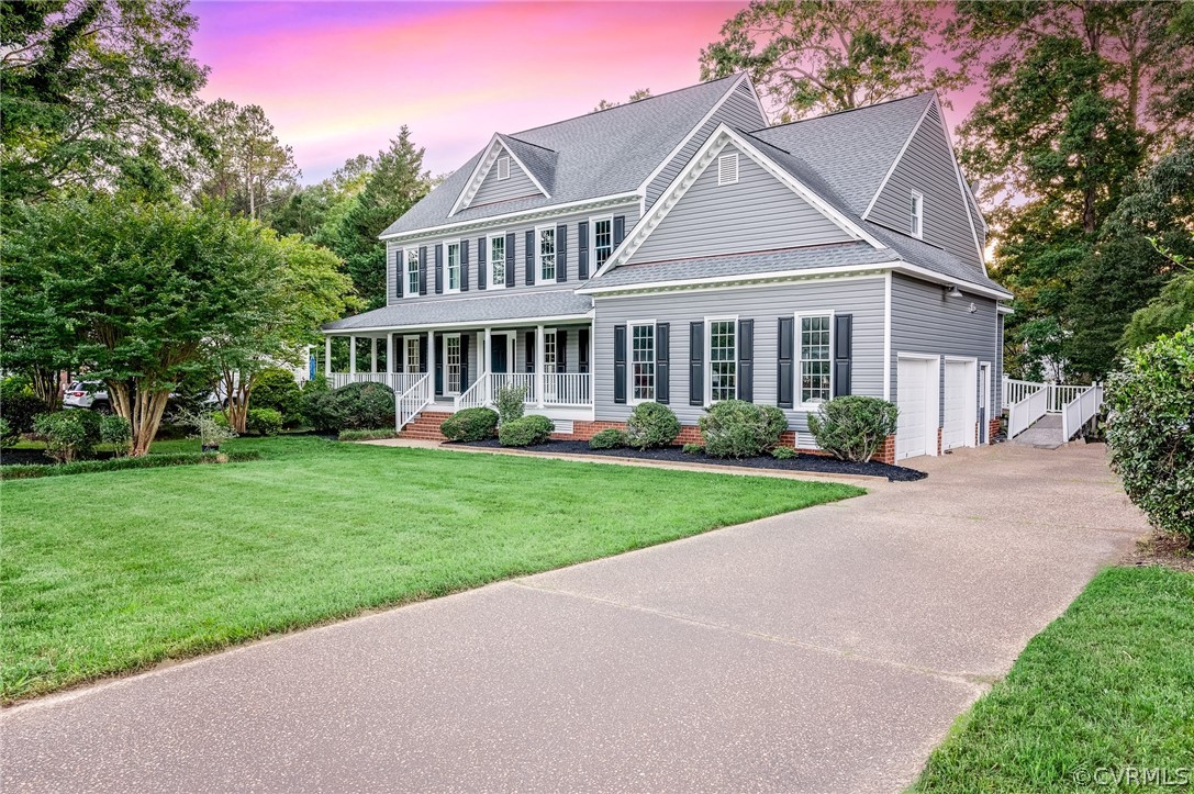 12604 Hogans Drive Chester, VA 23836 - Photo 1 of 1 a front view of a house with a garden and plants