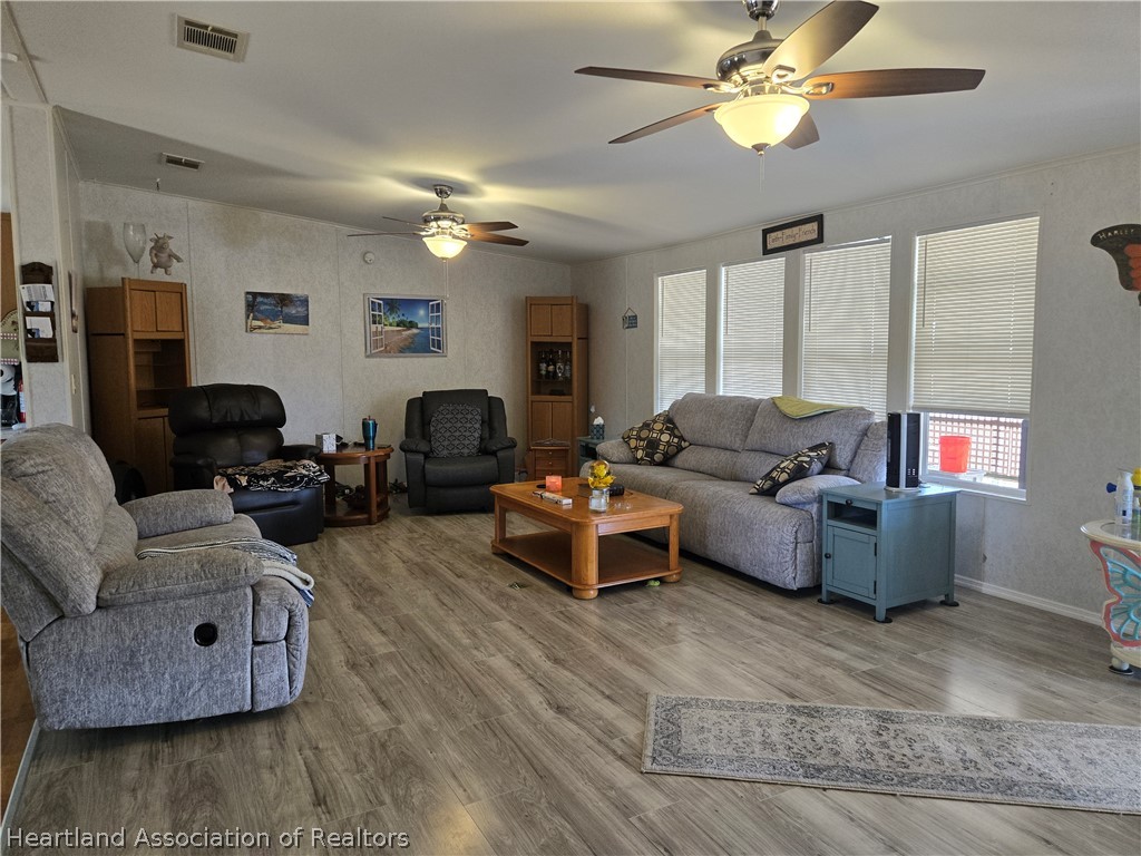504 Thunderbird Hill Road Sebring, FL 33872 - Photo 17 of 35 a living room with furniture and a wooden floor