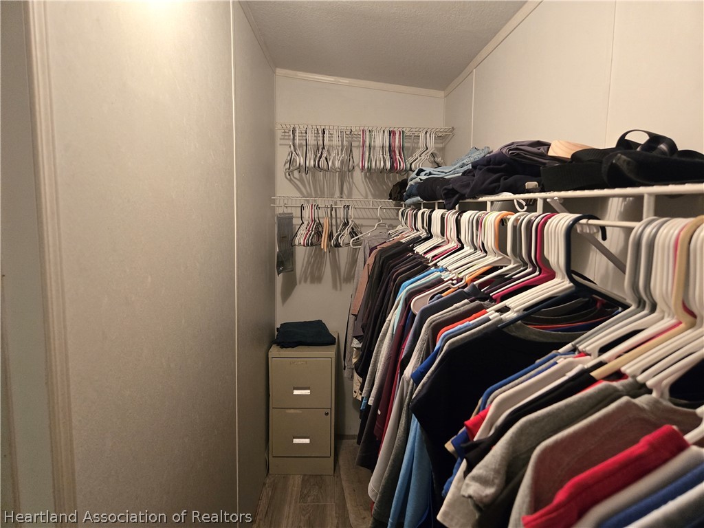 504 Thunderbird Hill Road Sebring, FL 33872 - Photo 25 of 35 a view of walk in closet with clothes and shoes