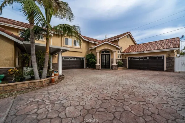 a view of a house with a yard and a garage